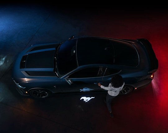 2024 Ford Mustang® Dark Horse™ model with a driver approaching the vehicle | Sarchione Ford of Randolph in Randolph OH